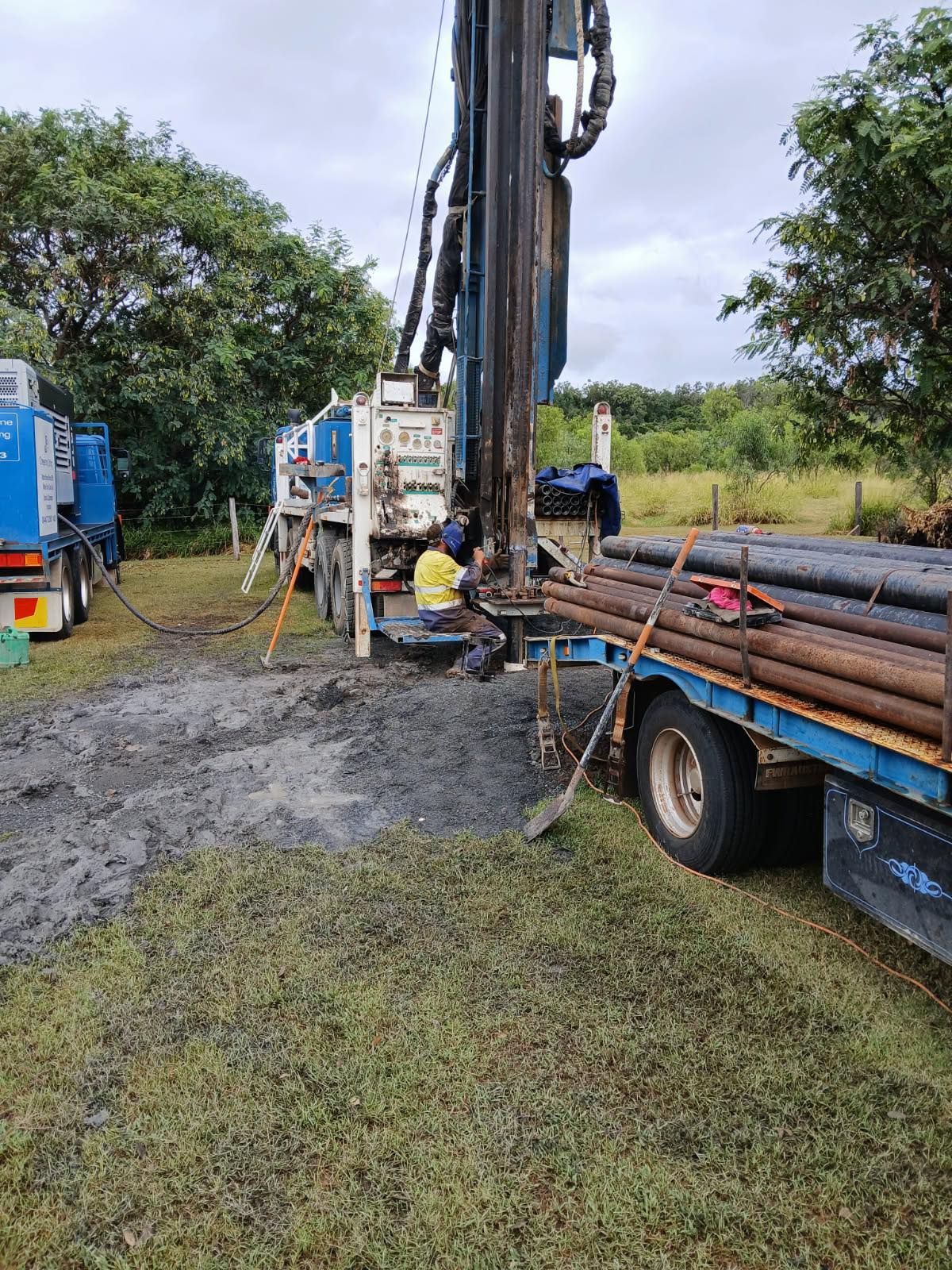 A Man and a Woman Are Standing Next to a Pole in a Dirt Field — Cheyenne Drilling on the Sunshine Coast, QLD