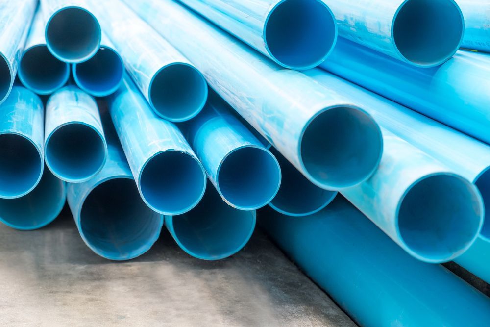 A Pile of Blue Plastic Pipes Stacked on Top of Each Other on the Ground — Cheyenne Drilling on the Sunshine Coast, QLD