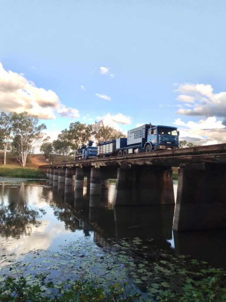 A Train is Crossing a Bridge Over a Body of Water — Cheyenne Drilling on the Sunshine Coast, QLD