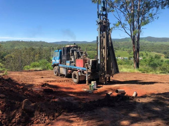 A Truck is Driving Down a Dirt Road Next to a Tree — Cheyenne Drilling on the Sunshine Coast, QLD