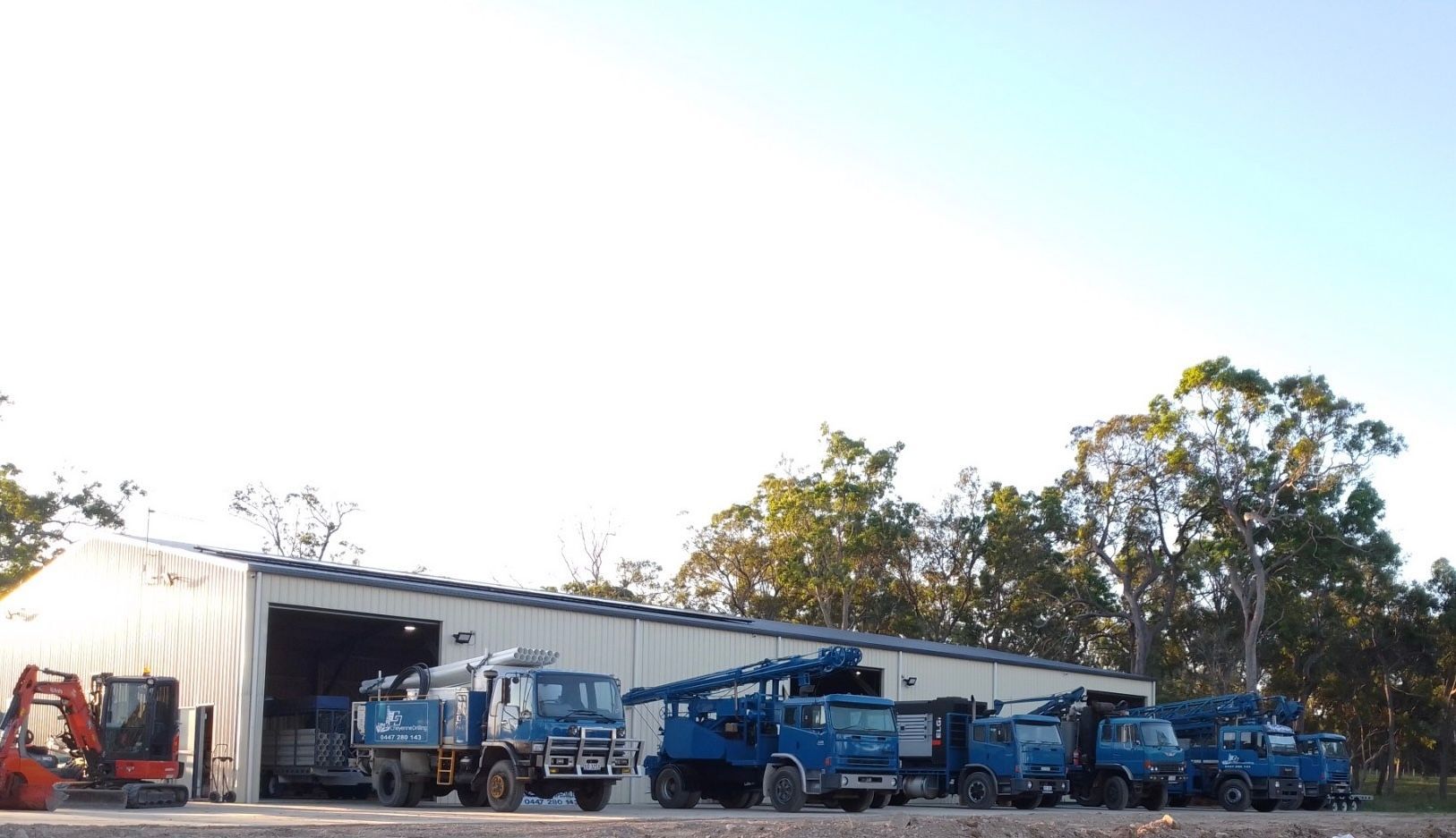 A Truck is Being Lifted by a Crane in a Dirt Field — Cheyenne Drilling on the Sunshine Coast, QLD