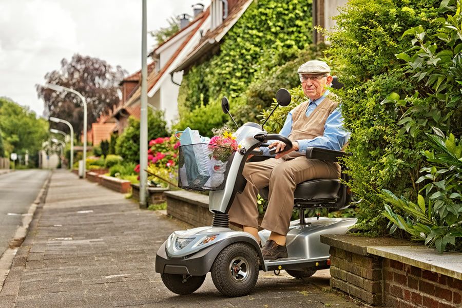 An Elderly Person Drives an Electric Vehicle — Healthcare Equipment in Lake Macquarie