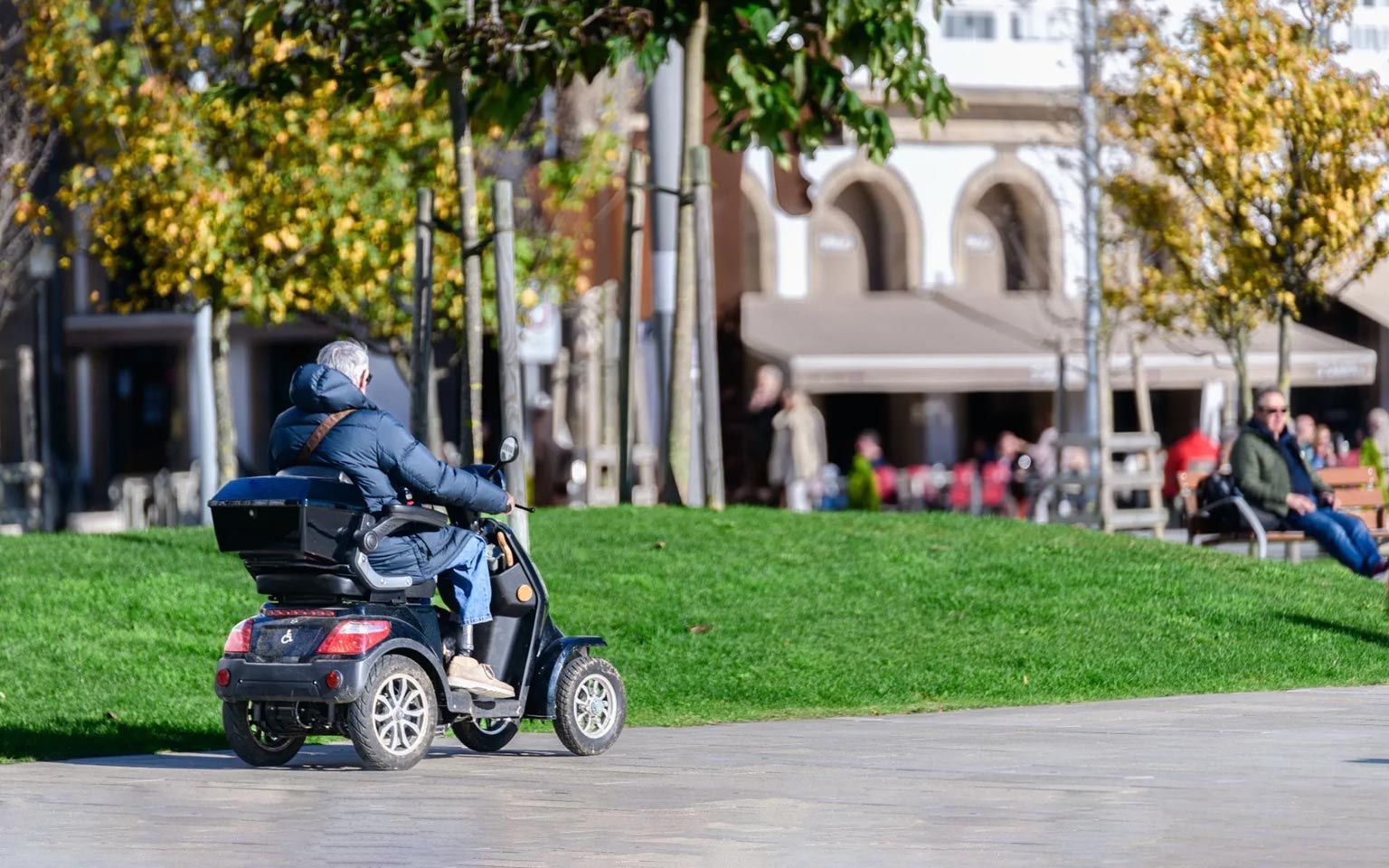 A Man Riding A Mobility Aid