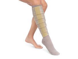 A woman is wearing a bandage on her leg.