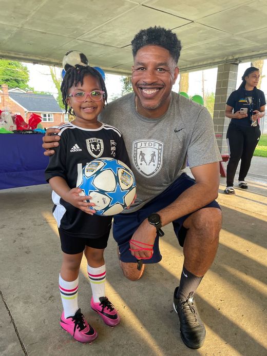 JT Dorsey and a youth soccer player from the foundation 