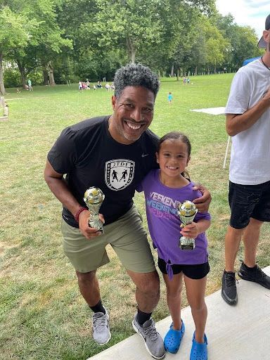 JT Dorsey and a participant of the foundation holding their awards