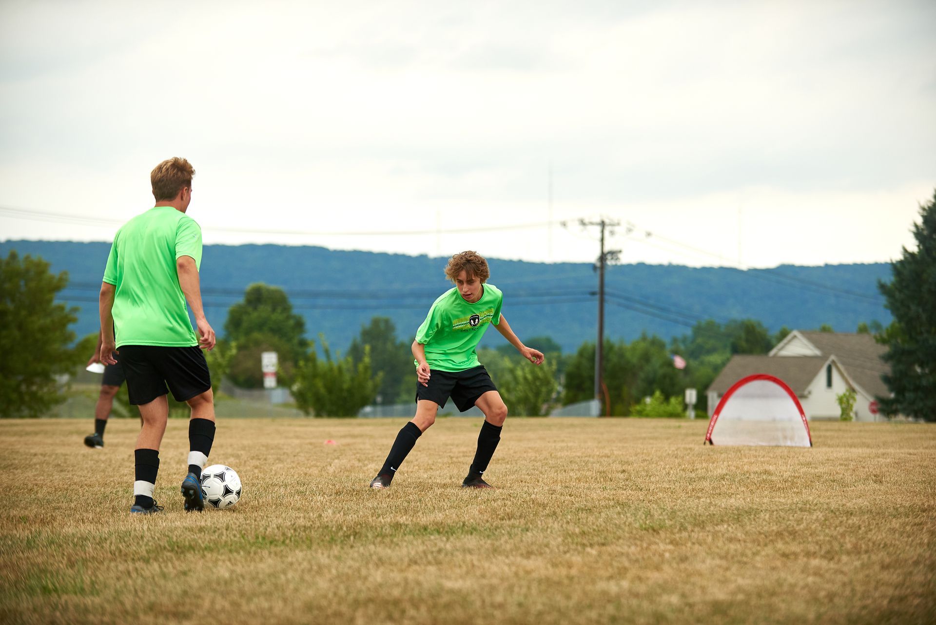 Two boys from the JTDF Skills School playing soccer