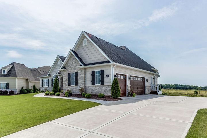 A large white house with a driveway in front of it
