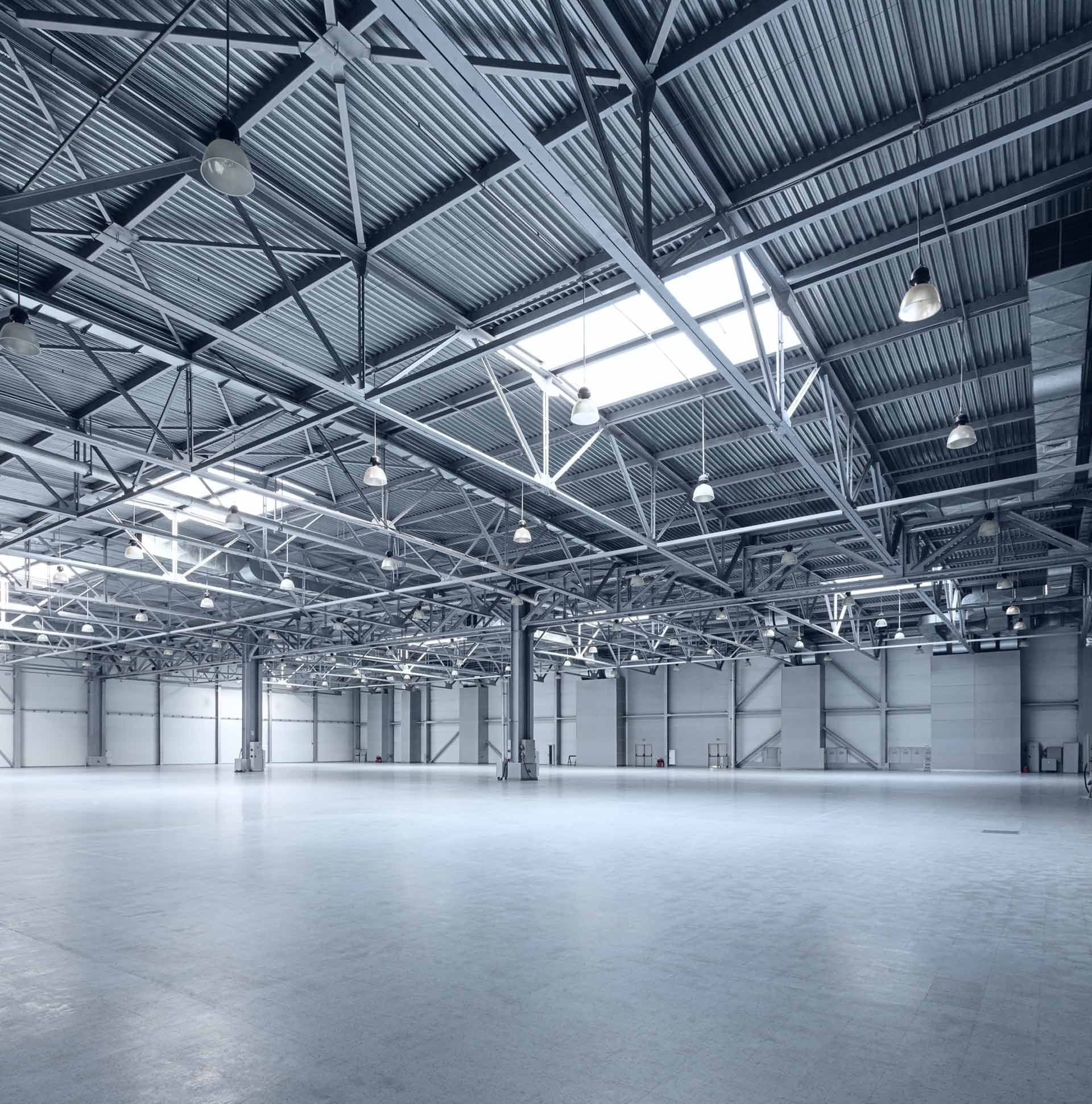 A large empty warehouse with a skylight in the ceiling