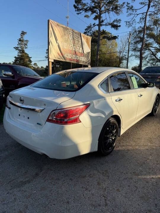 White sedan parked in a lot at sunset, with a billboard and other cars in the background