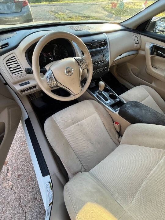 Tan car interior with beige seats, steering wheel, and center console in daylight