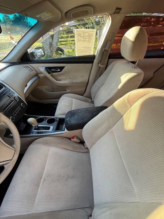 Car interior with beige seats, dashboard, and center console in daylight