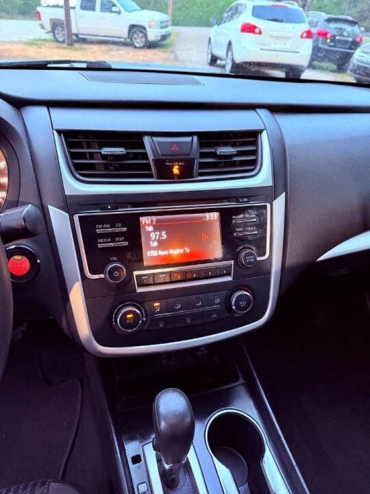 Car dashboard and center console with infotainment screen, vents, climate controls, and gear shift