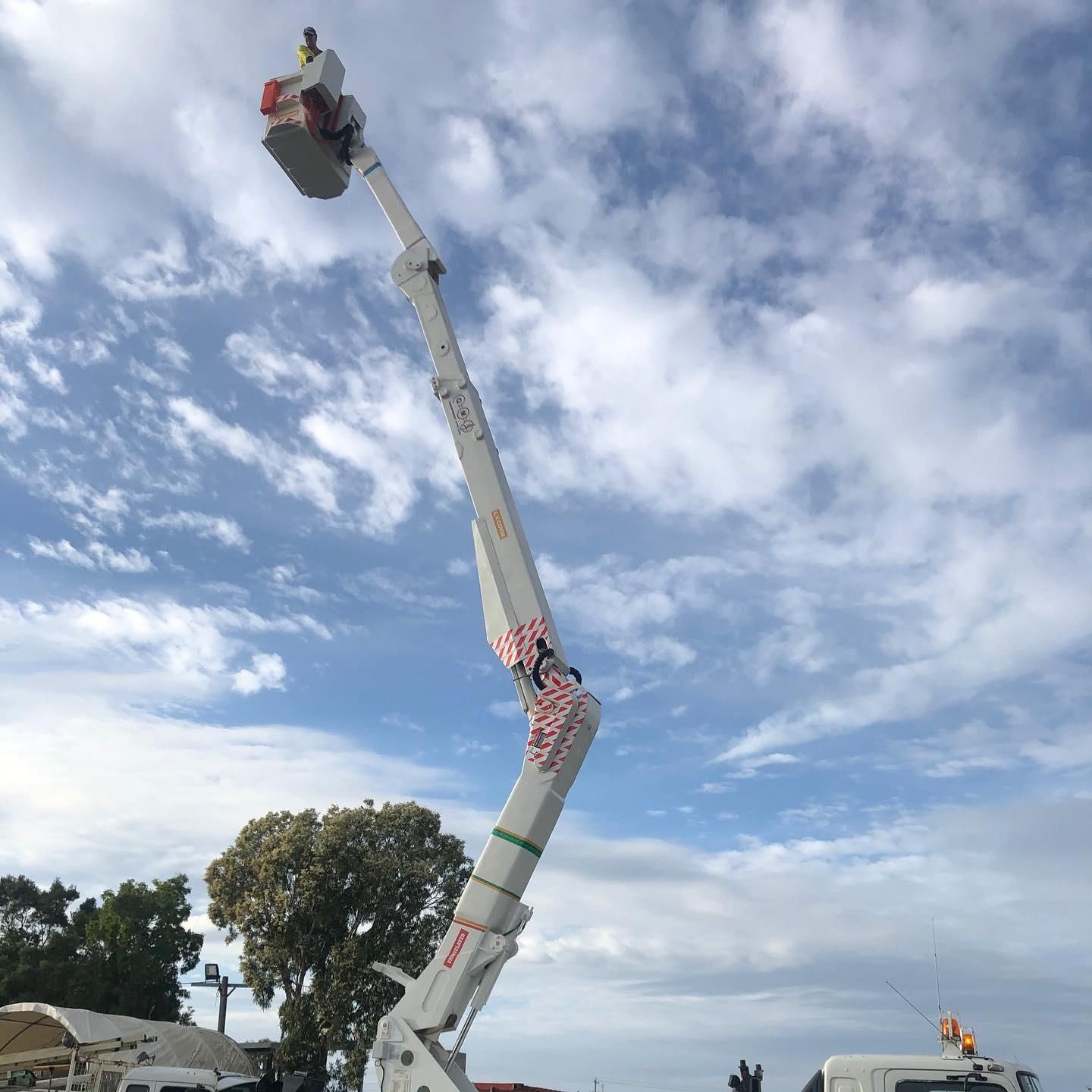 A Crane is Sitting on Top of a Truck With a Blue Sky in the Background — Rob Ward Electrical Services in Ballina, NSW