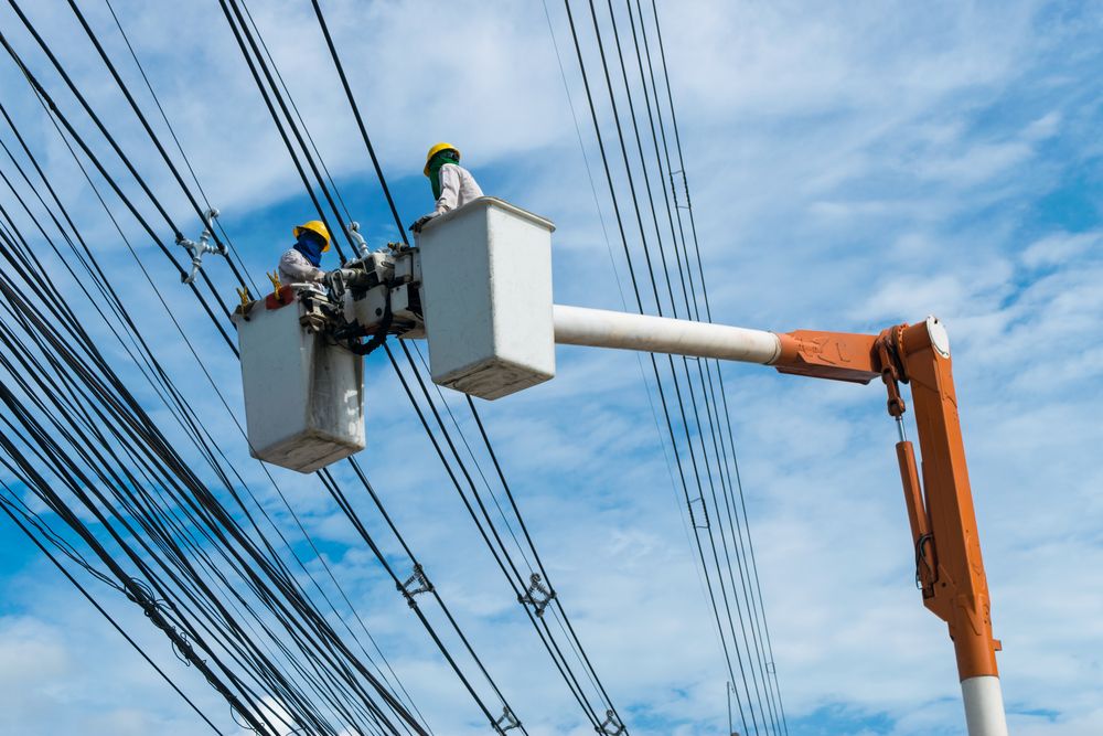 Two Men Are Working on Power Lines in a Bucket — Rob Ward Electrical Services in Lismore, NSW
