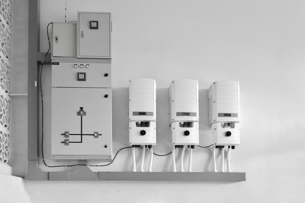 A Black and White Photo of a Row of Electrical Boxes on a Wall — Rob Ward Electrical Services in West Ballina, NSW