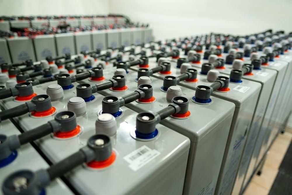 A Row of Batteries Are Lined Up in a Room — Rob Ward Electrical Services in Wardell, NSW