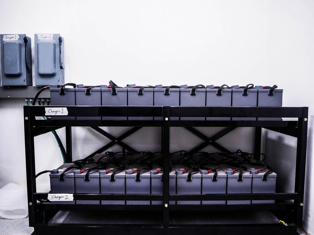A Bunch of Batteries Are Stacked on Top of Each Other on a Rack — Rob Ward Electrical Services in Tweed Heads, NSW