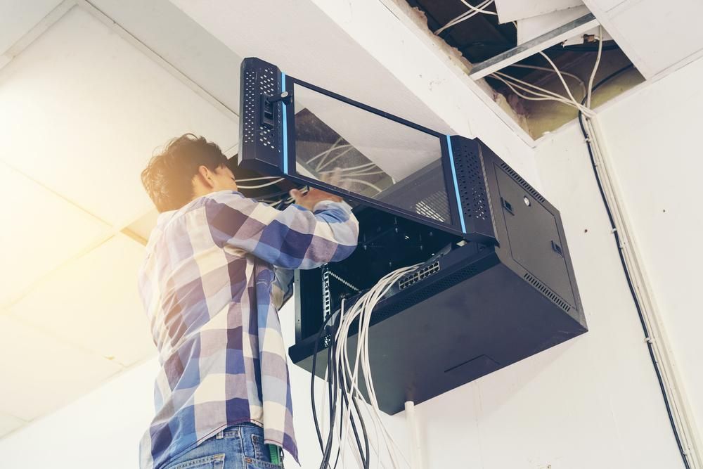 A Man is Working on a Server in a Server Room — Rob Ward Electrical Services in West Ballina, NSW