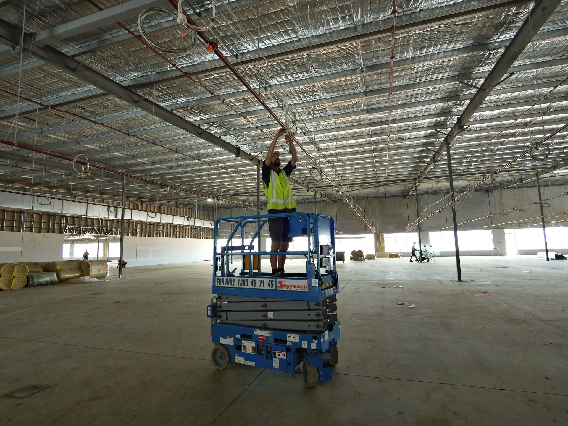 Person on a Lift Working on Overhead Wires — Rob Ward Electrical Services in Ballina, NSW