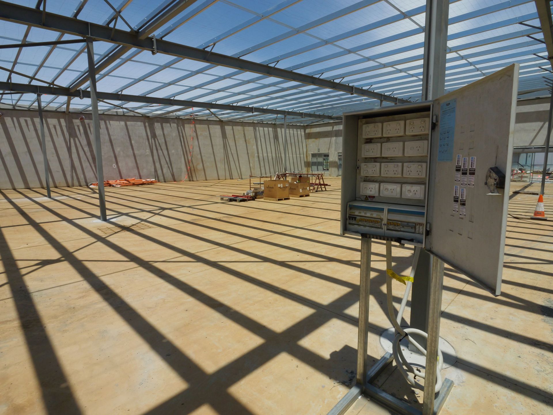 Electrical panel in a partially constructed building interior with metal framing and concrete floor— Rob Ward Electrical Services in West Ballina, NSW