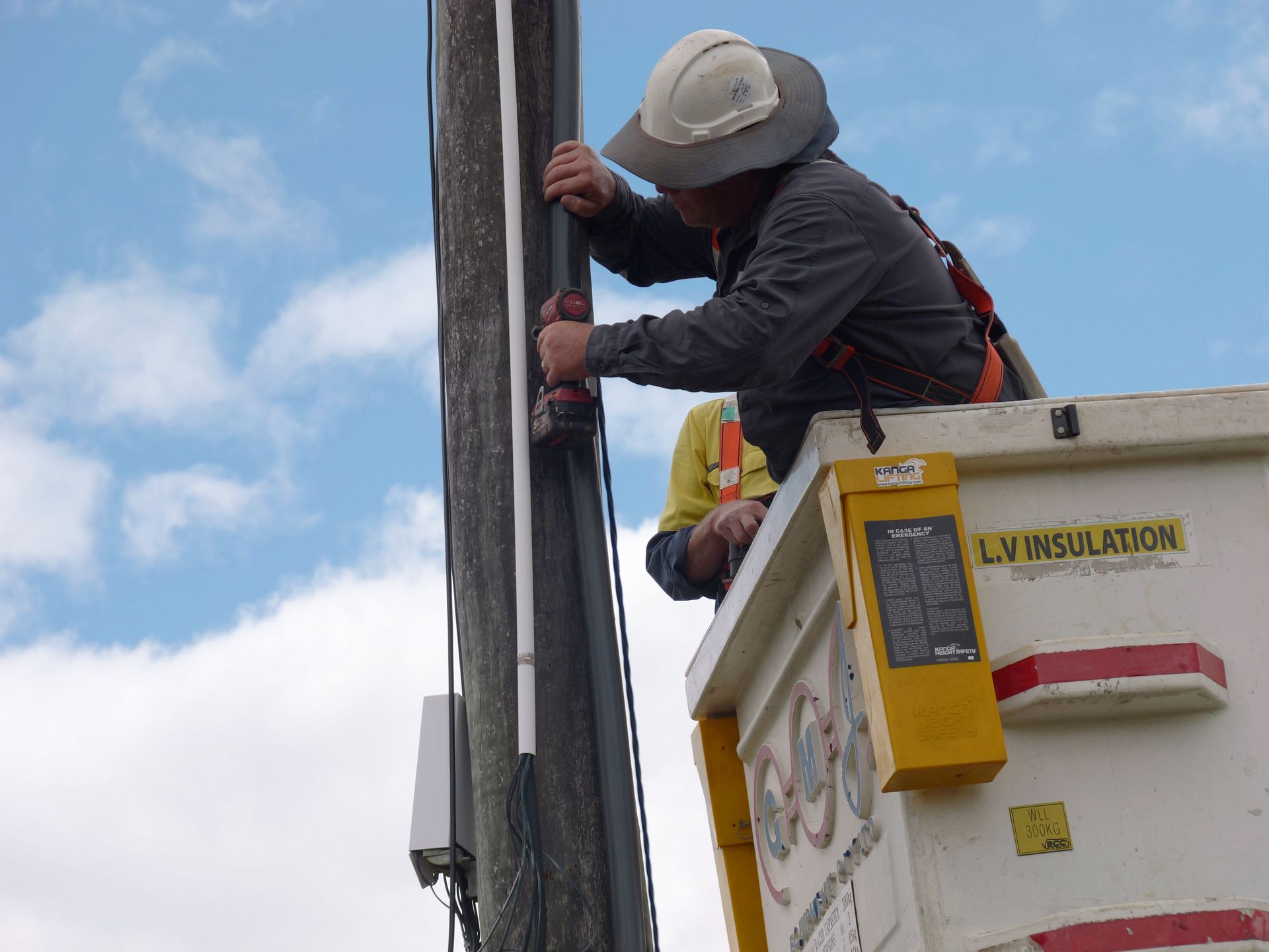 Lineman on a Lift Repairs Electrical Pole — Rob Ward Electrical Services in Tweed Heads, NSW