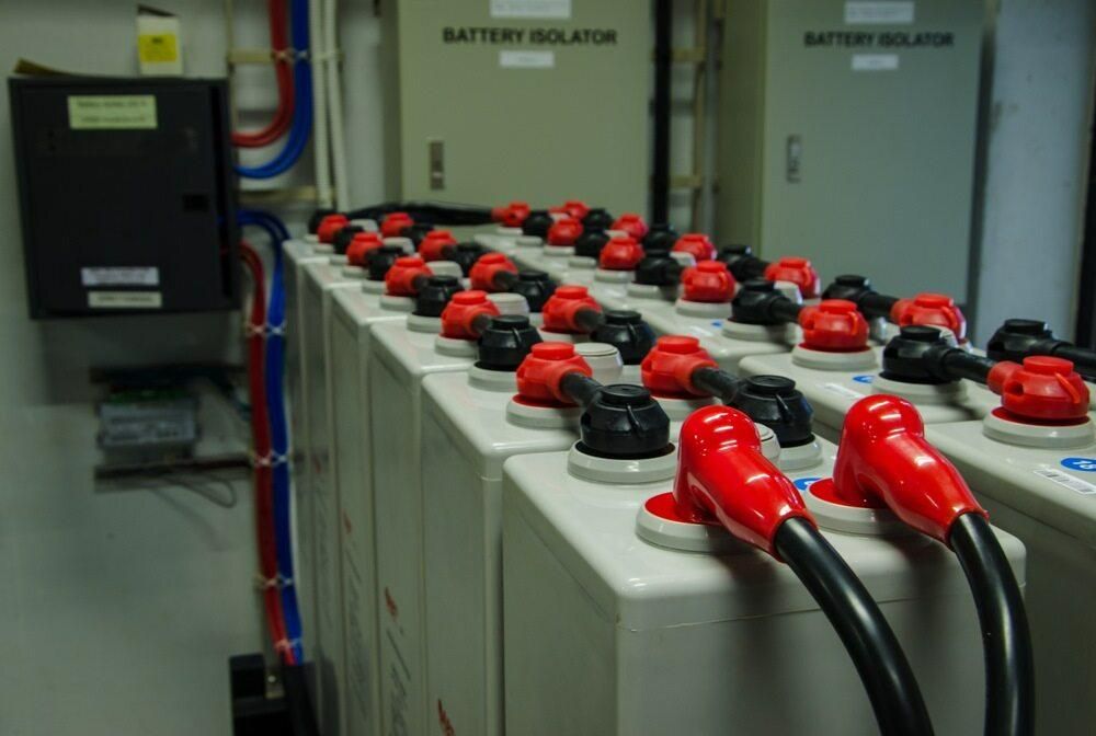A Row of Batteries Are Connected to a Battery Isolator — Rob Ward Electrical Services in Alstonville, NSW