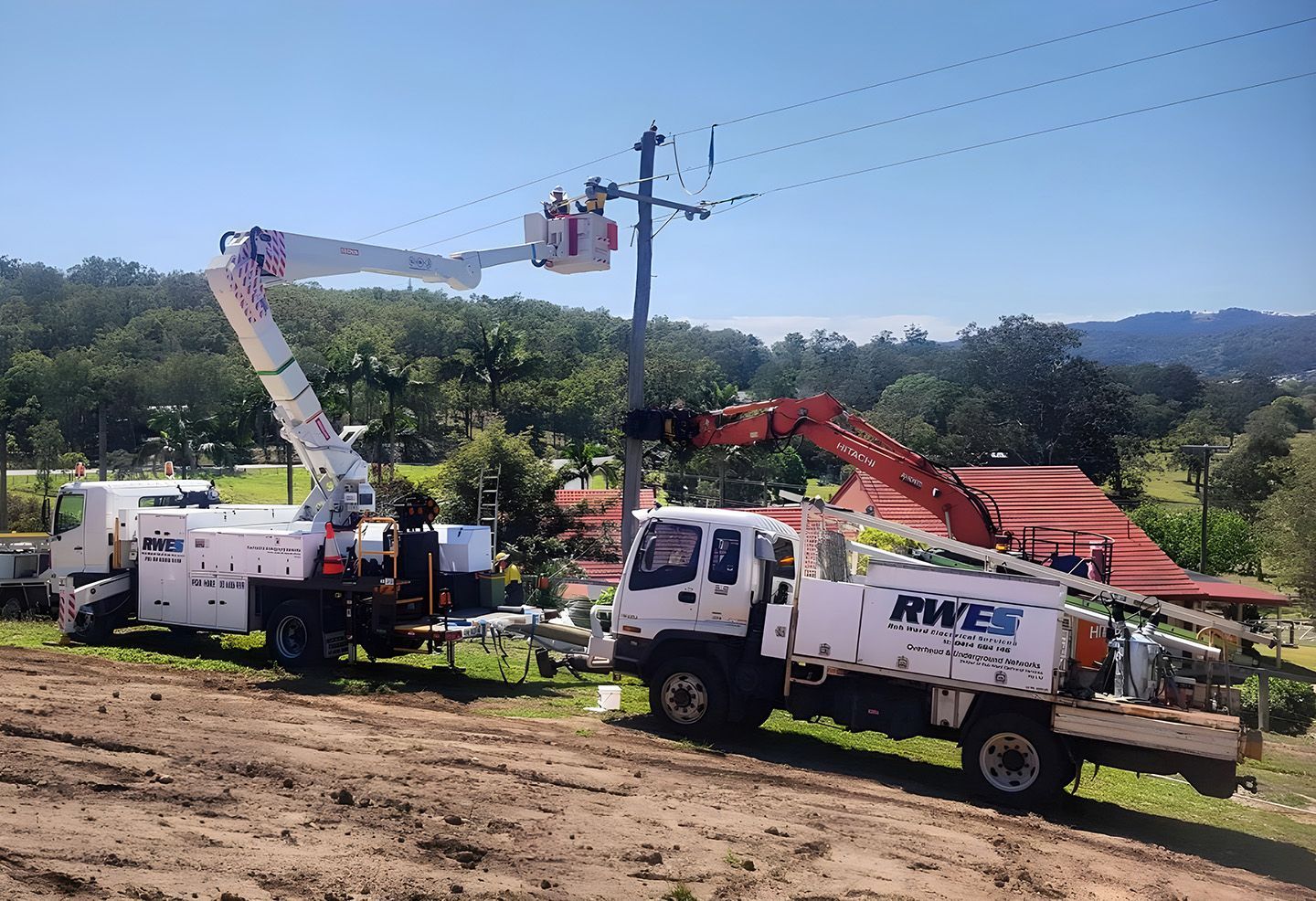 Electrical Maintenance Crew Servicing Power Lines With Boom Lifts