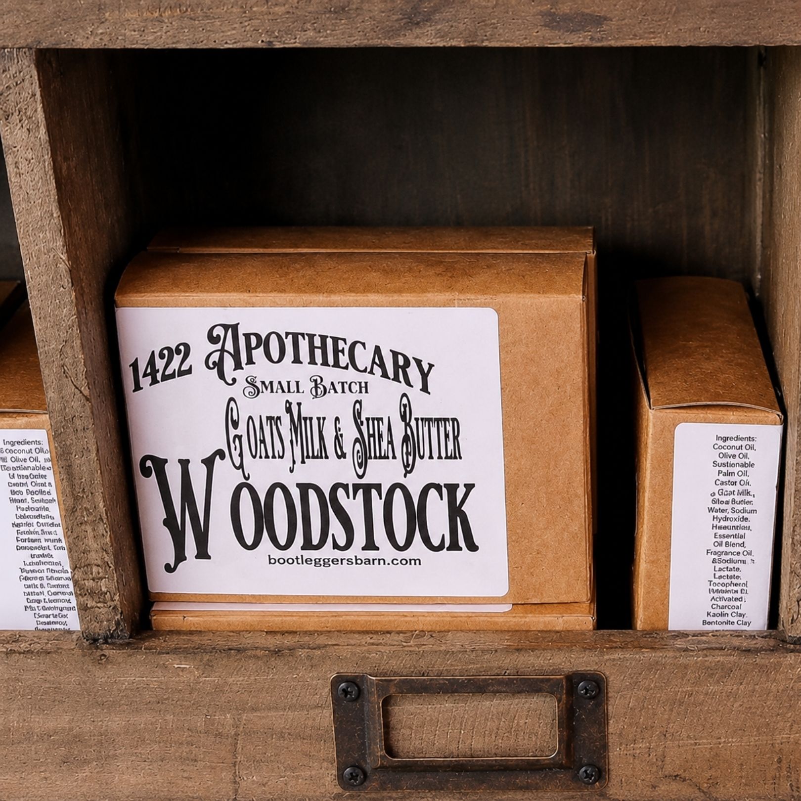 Woodstock apothecary sign on a small wooden box display, flanked by two narrow labeled boxes.