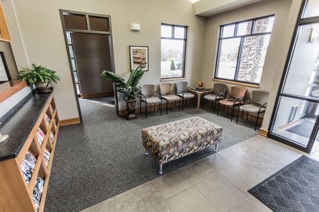 Best general dentist in Lee's Summit, MO and surrounding areas. A waiting room with a bench and chairs in a dental office.