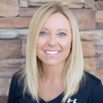 Best same day dentist in Lee's Summit, MO and surrounding areas. A woman with blonde hair is smiling in a circle in front of a brick wall.