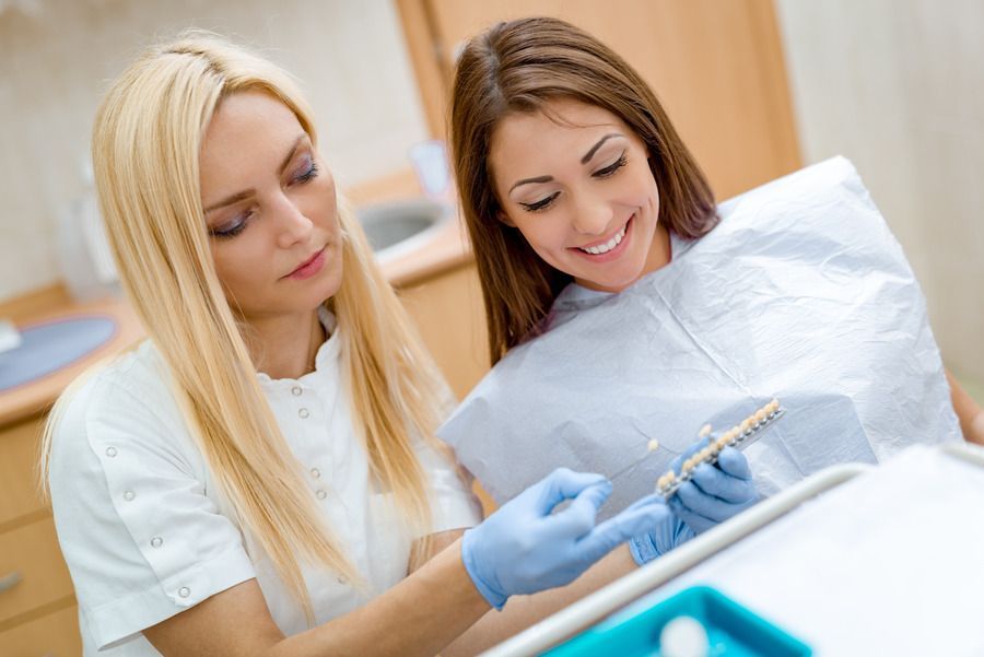 woman smiling in dental chair after getting same day emergency dental care in Lees Summit MO