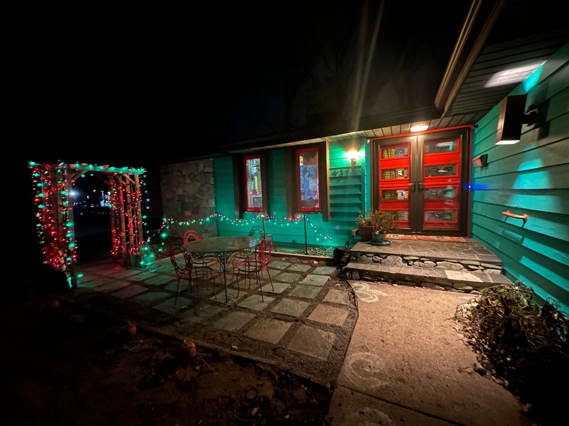 A house is decorated with christmas lights at night.