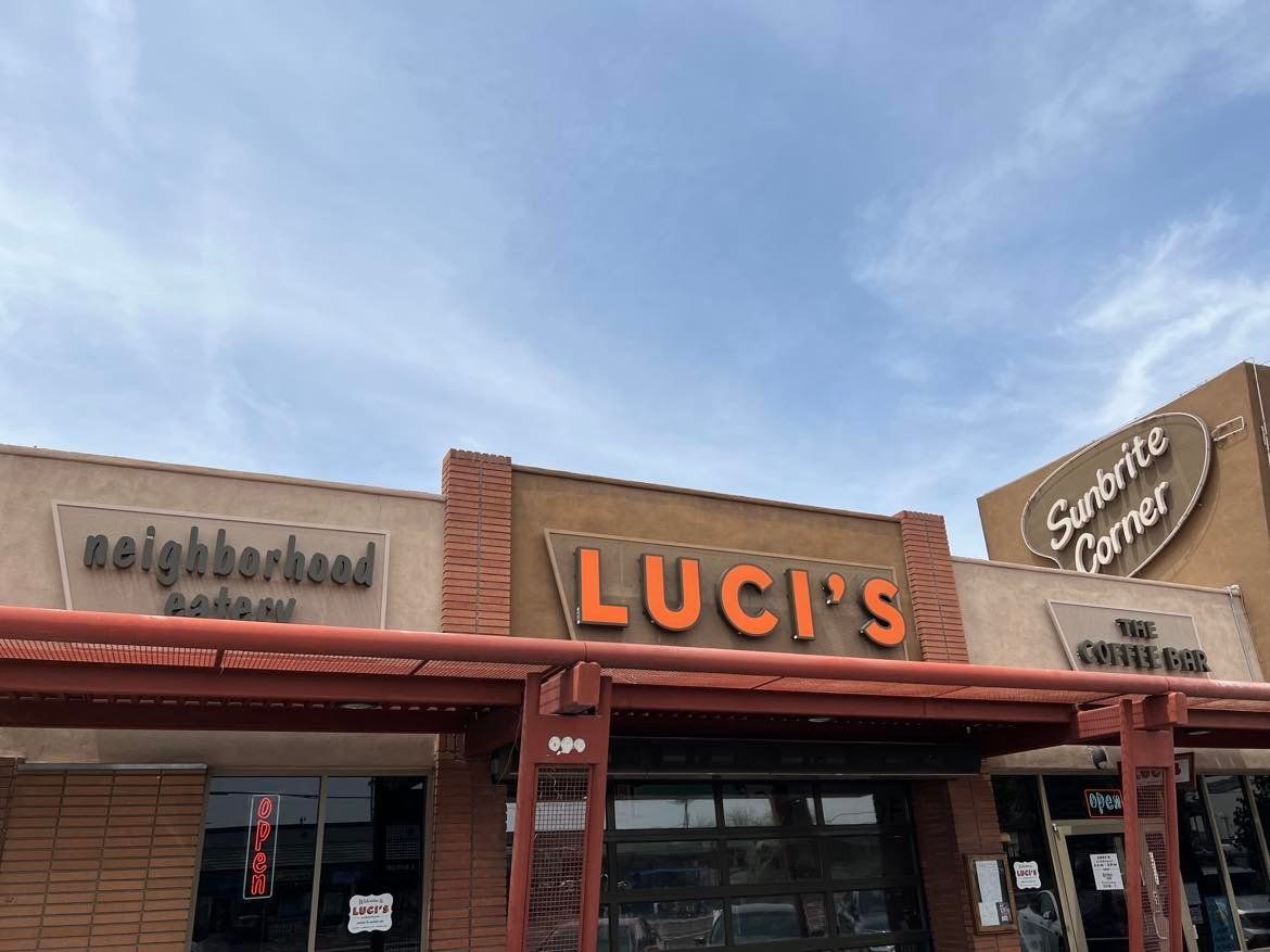 A building with a sign that says luci 's on it