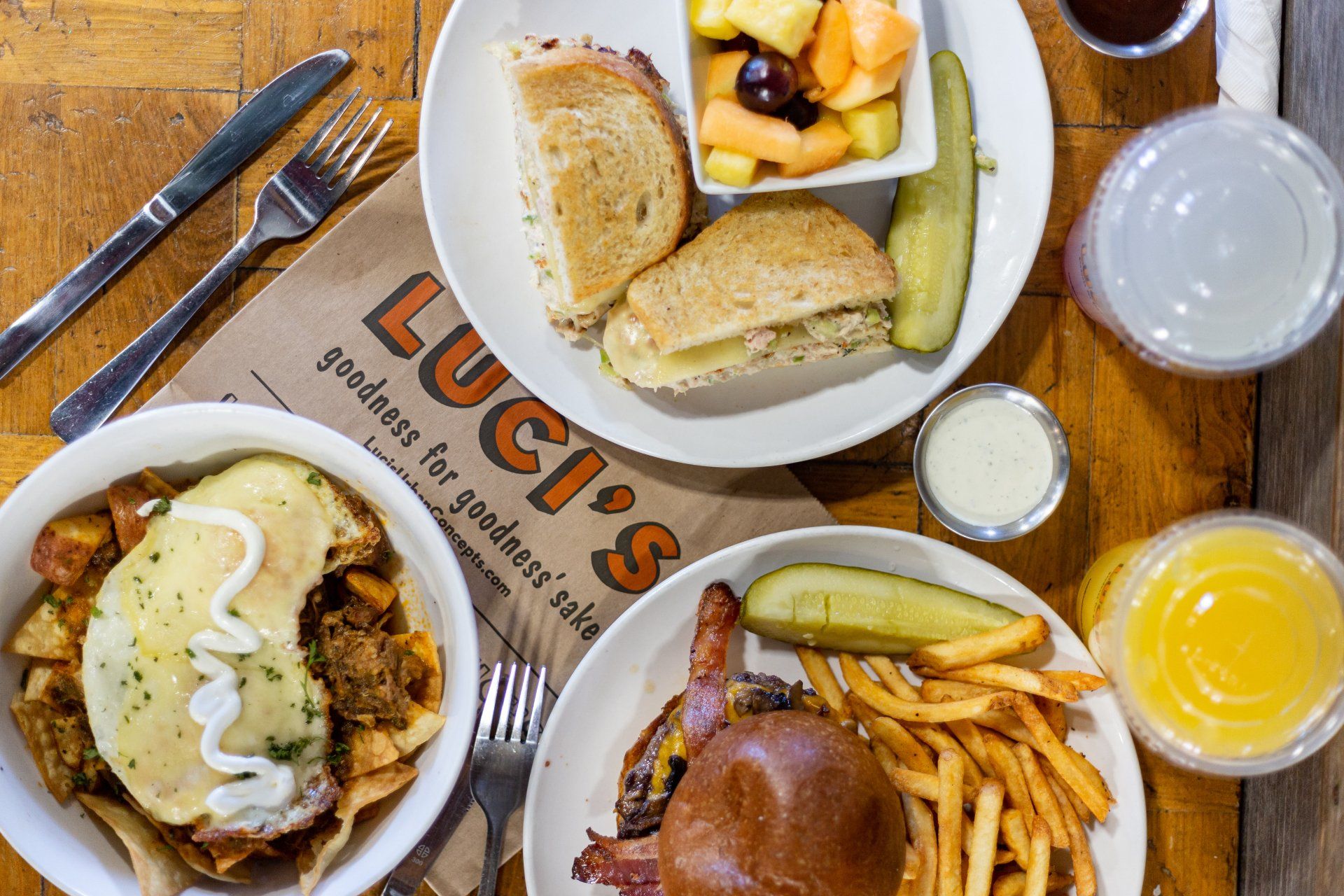 A table topped with plates of food from luci 's restaurant