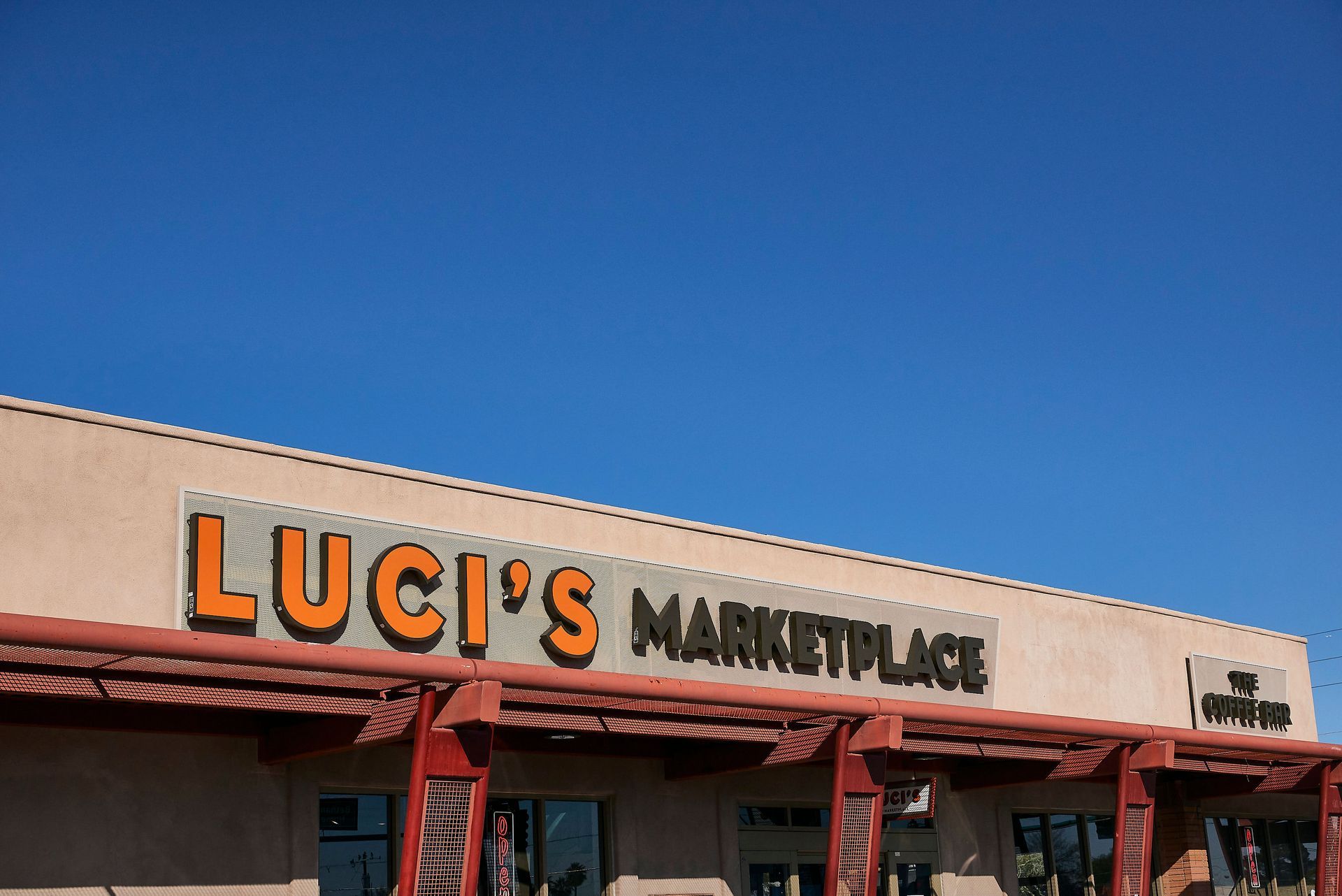 luci 's marketplace with a blue sky in the background