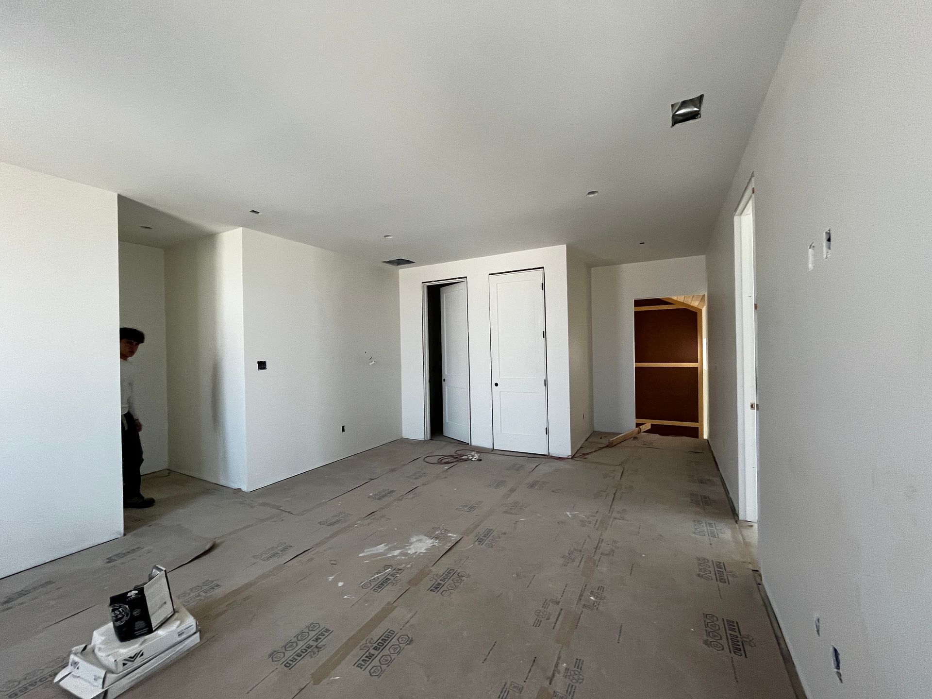 An empty room with a man standing in the doorway