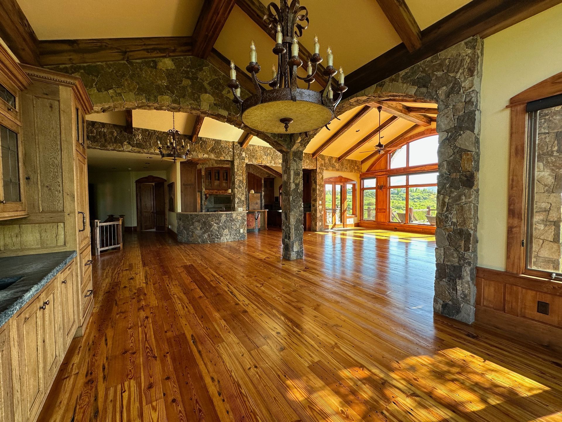 A large room with hardwood floors and a chandelier