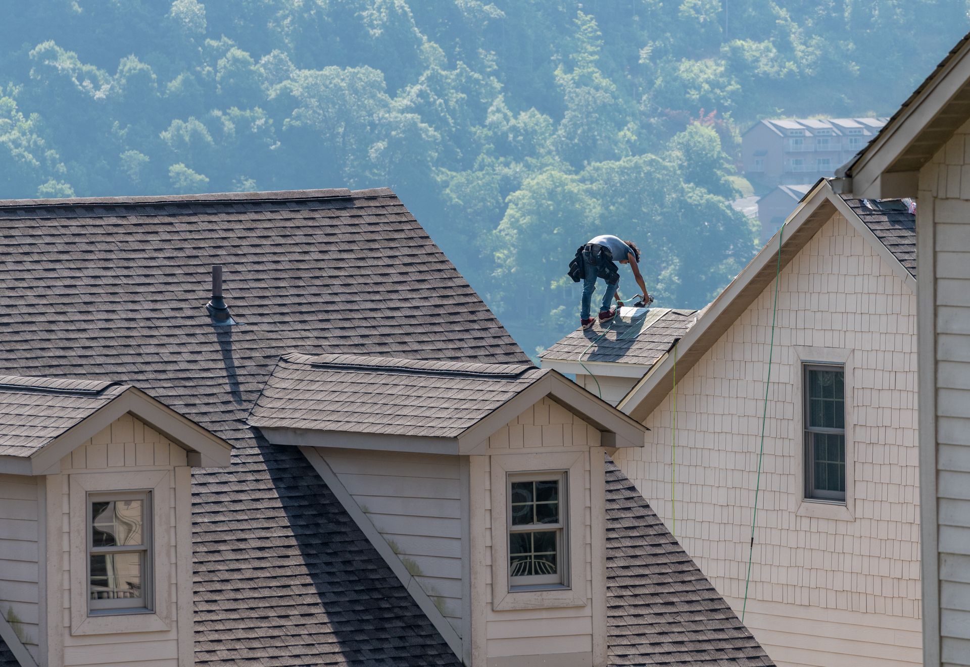 A roof replacement contractor replaces the clay tile roof covering of a home. A roof replacement contractor replaces the clay tile roof covering of a home.