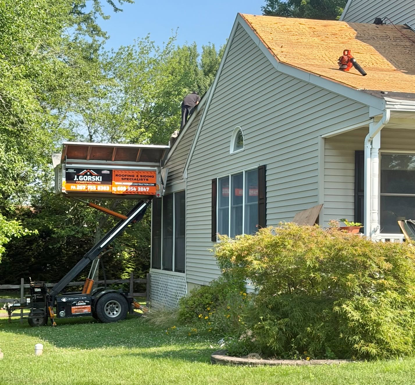 A roof replacement contractor replaces the clay tile roof covering of a home. A roof replacement contractor replaces the clay tile roof covering of a home.