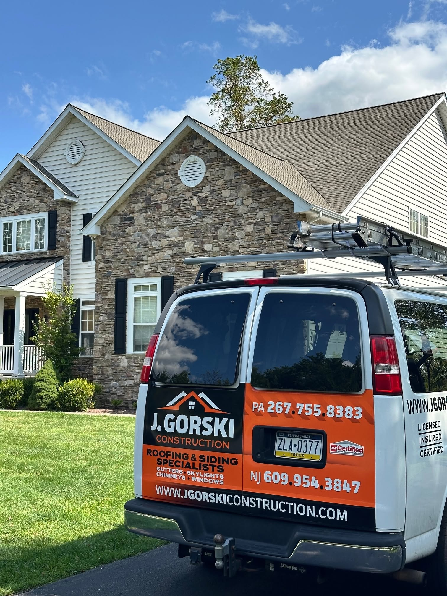 Roofing contractors installing shingles on a residential roof. Roofing contractors installing shingles on a residential roof.