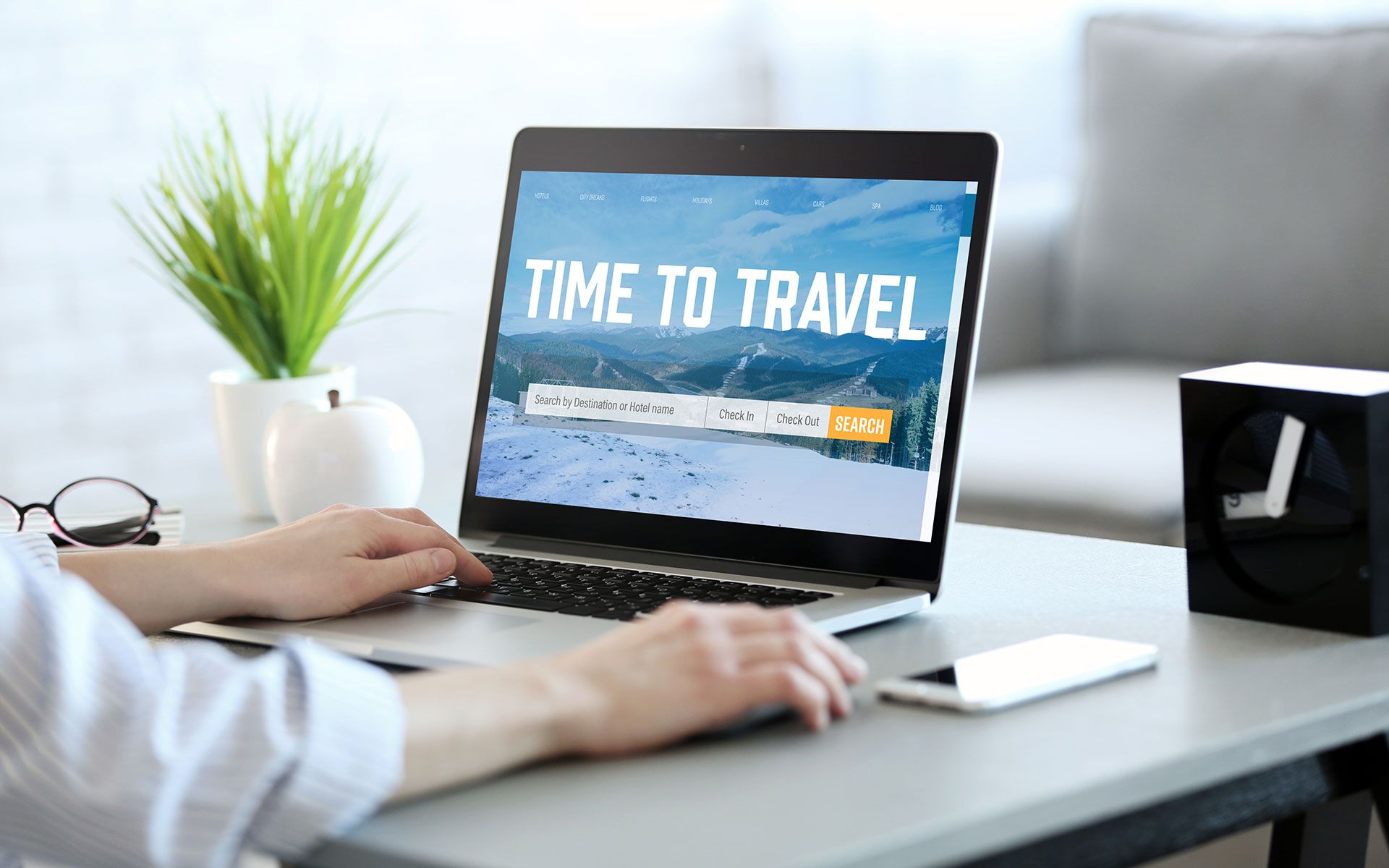 Person using laptop on desk with 