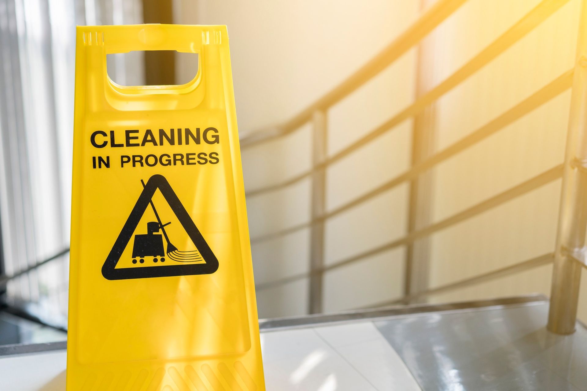 A cleaning in progress sign is placed in front of the stairs.