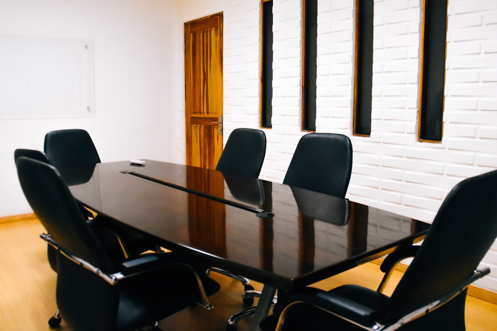 A clean conference room with a glass table.