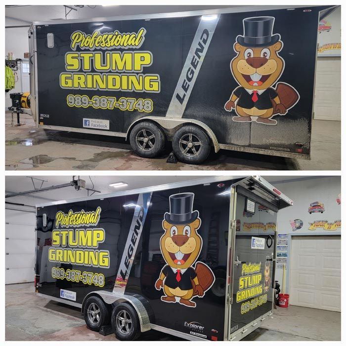 A trailer with a squirrel on it that says professional stump grinding