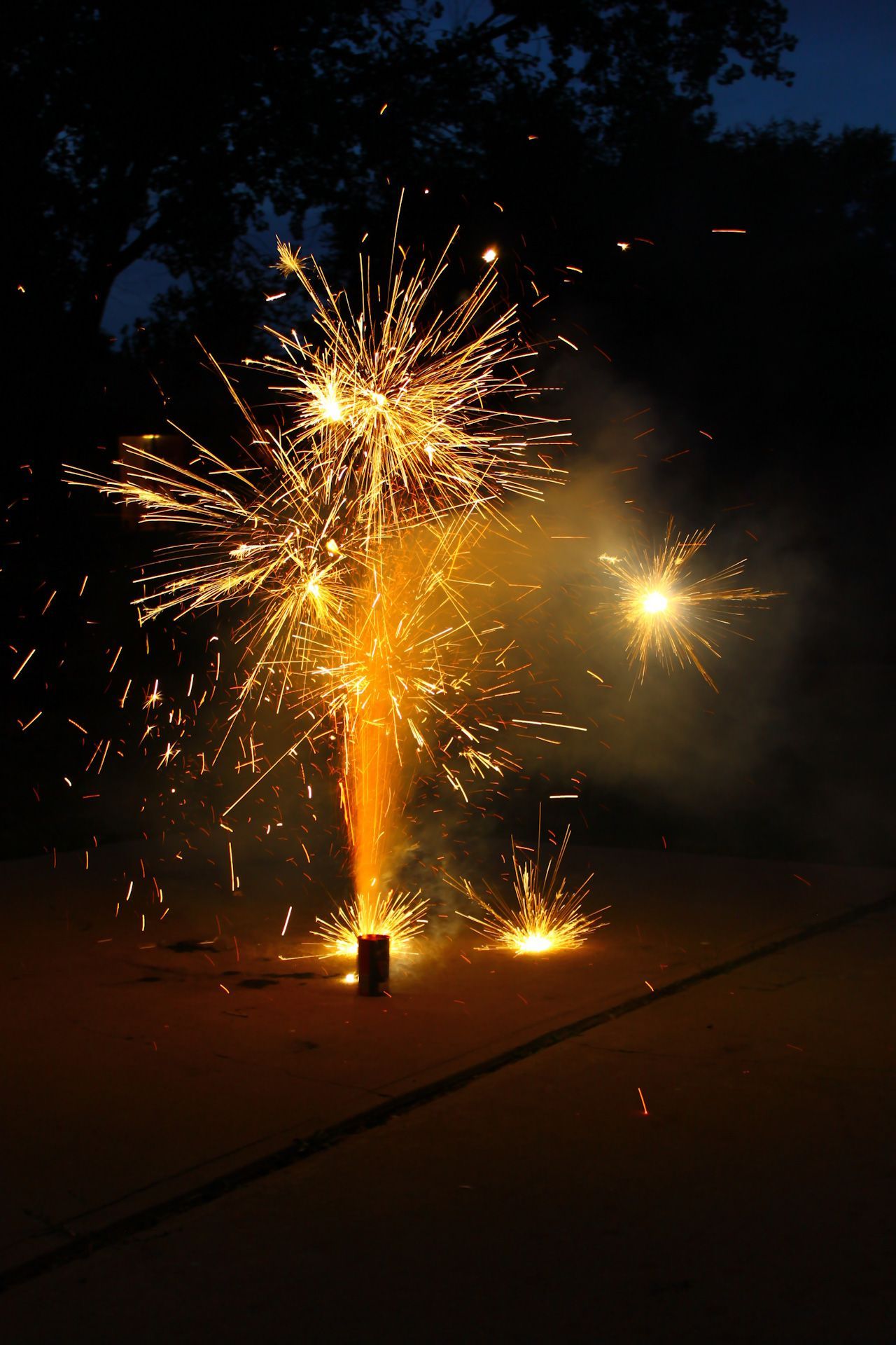 A fountain fireworks display is going off in the dark