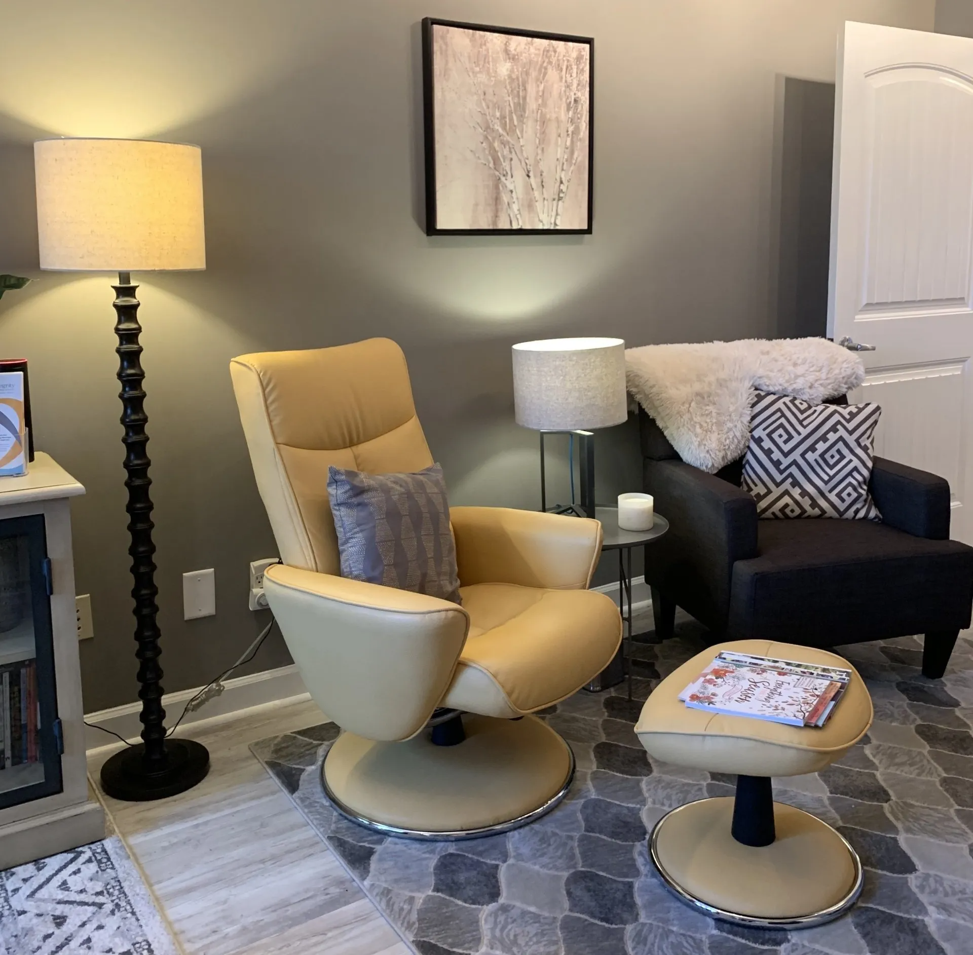 A living room with two chairs and a lamp