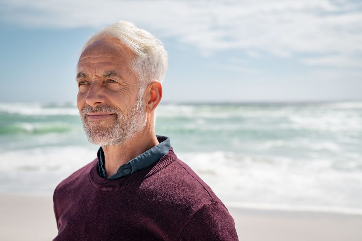 smiling senior man at the ocean