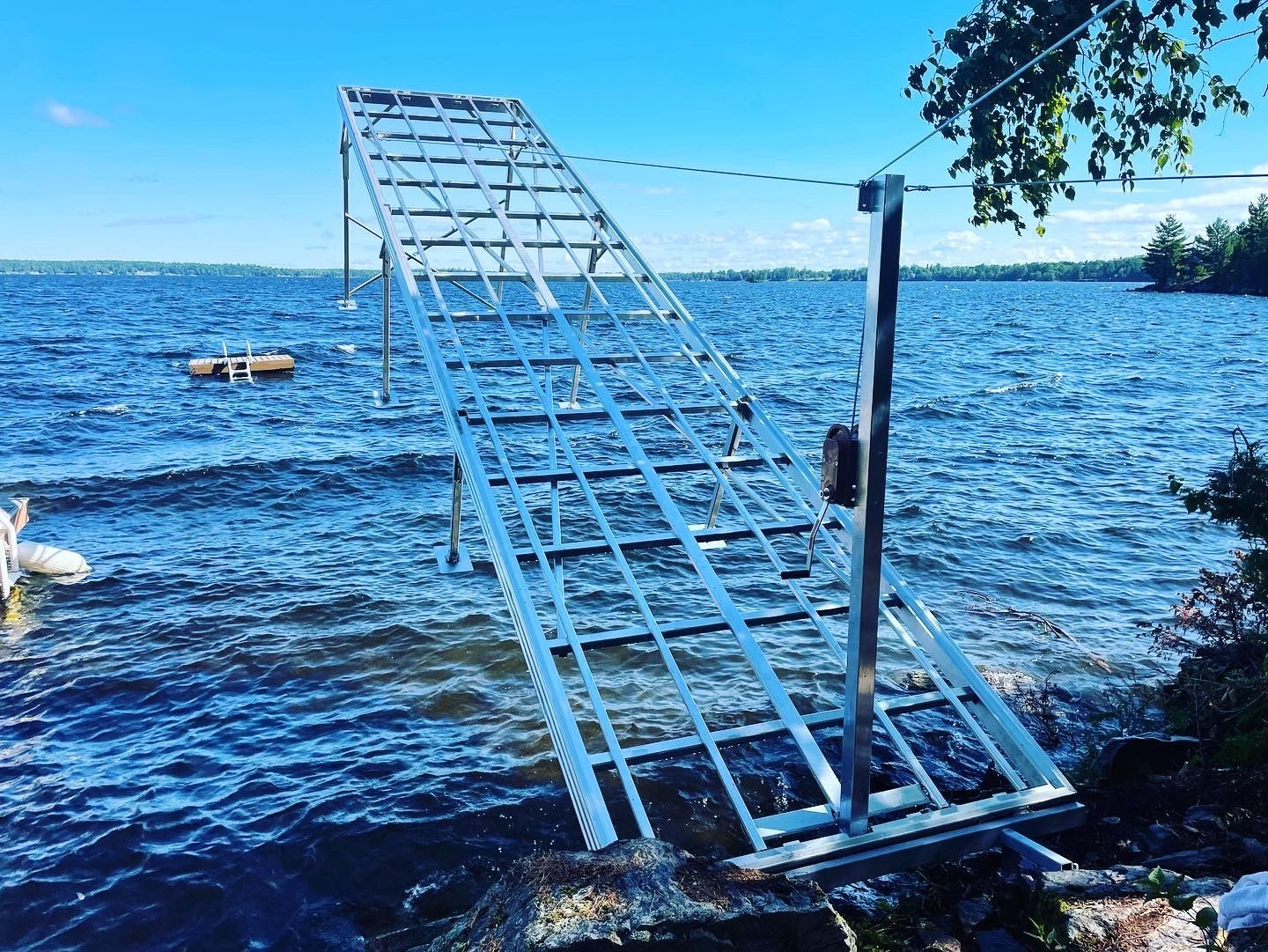 A large metal structure is sitting in the middle of a lake.