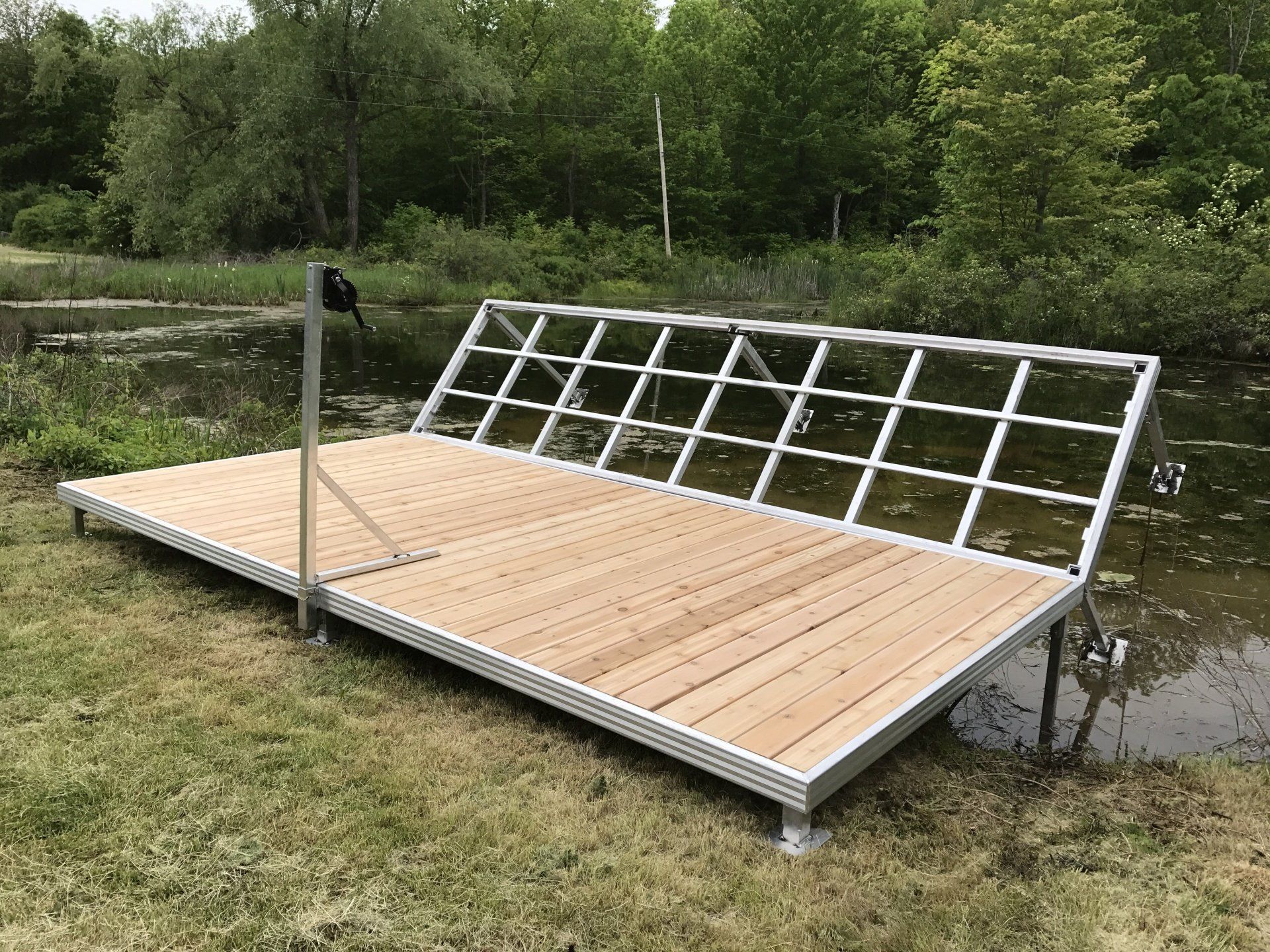 A wooden dock is sitting next to a body of water.